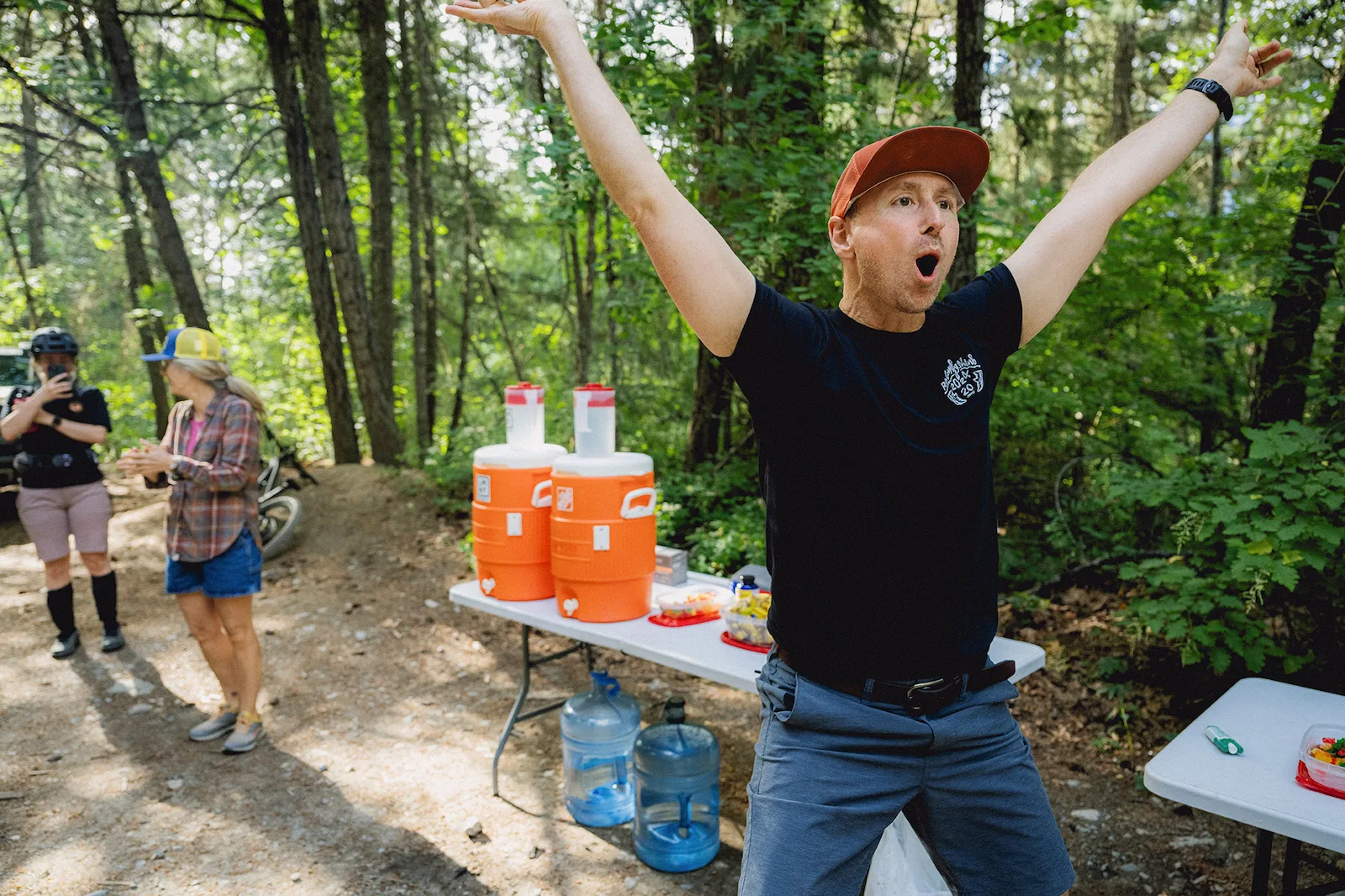 Runners on singletrack through old growth forest